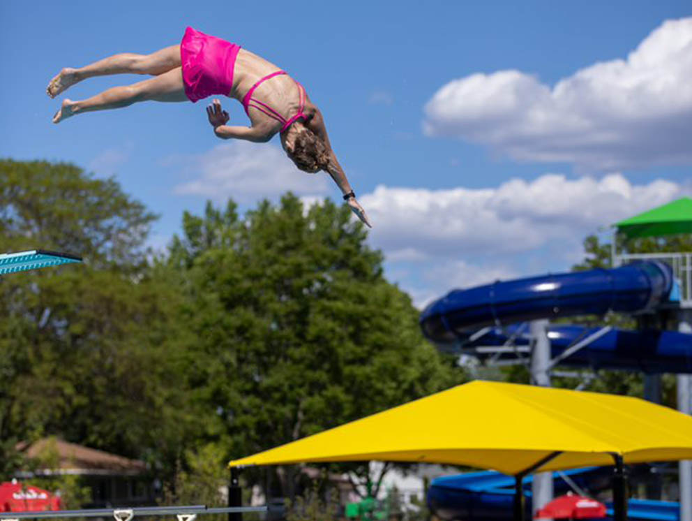 Girl diving into pool.