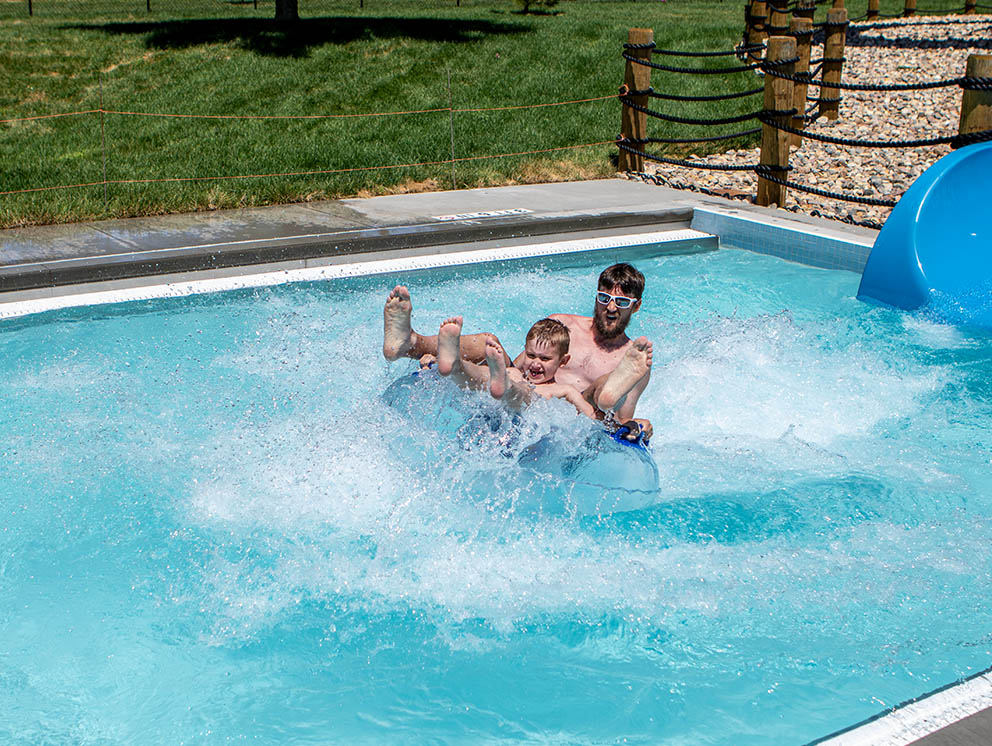 Father and son playing in the pool.