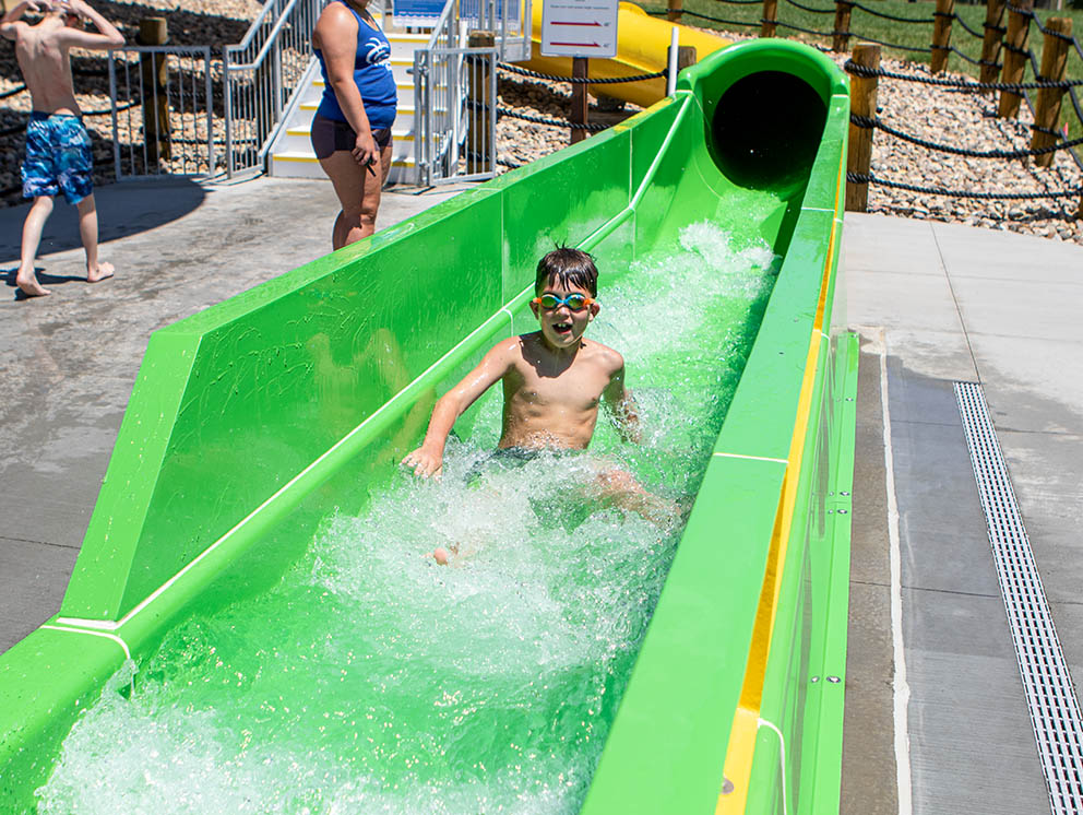 Boy traveling down water slide.