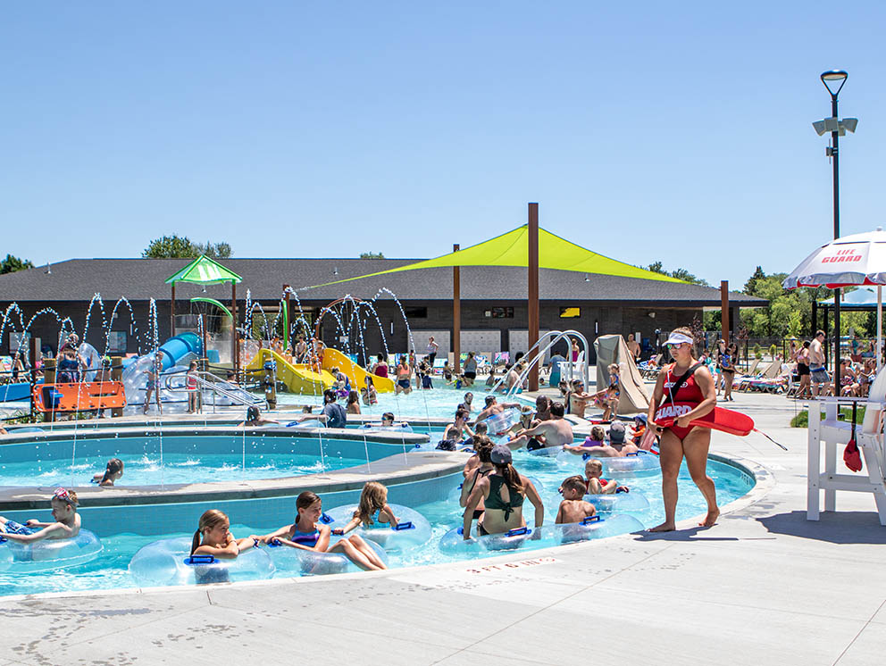 People and life guard in and near the Lazy River.